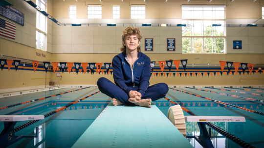 Photo of Kieran Cuddy sitting on a diving board