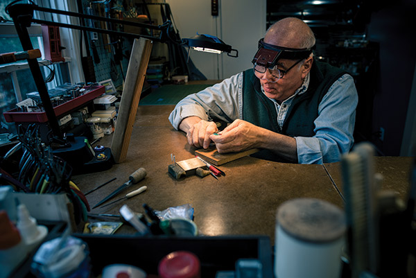Photo of Howard Zitsman working in his jewelry studio