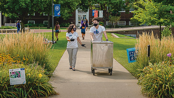 Photo of President Rivera on campus with a student