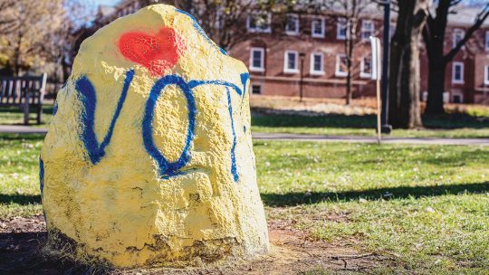 Photo of the Macalester Rock painted to read VOTE