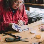 Photo of Walter “Super” LaBatte Jr. ’70 making beaded moccasins
