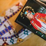Framed photo of Walter “Super” LaBatte Jr. on top of a beaded moccasin