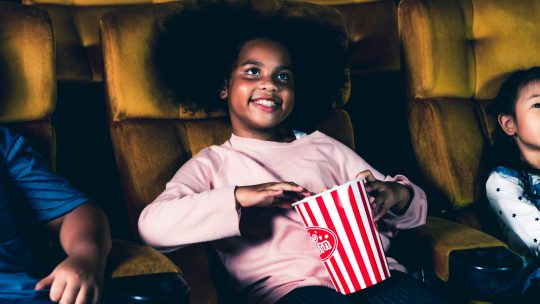 Photo of a child eating popcorn
