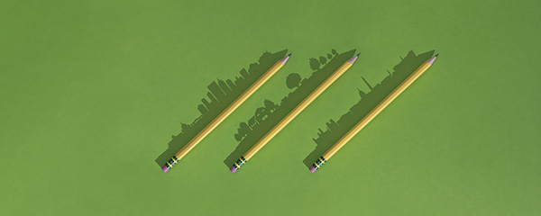 Three pencils in a diagonal row with silhouettes of skylines resting along them
