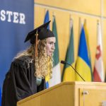 A graduating student speaks at the podium during Macalester's 2022 December Graduation.