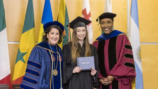 President Suzanne Rivera and Provost Lisa Anderson-Levy pose with a December 2022 graduate.