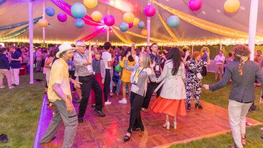 Alumni dancing under a disco ball at Macalester Reunion