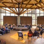 Members of the Macalester community gather in the chapel and listen as Rev. Kelly Stone speaks