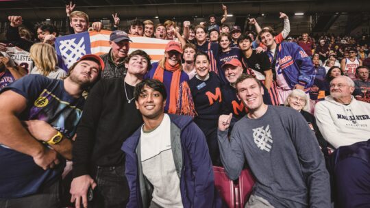 President Rivera and Macalester students at sporting event.