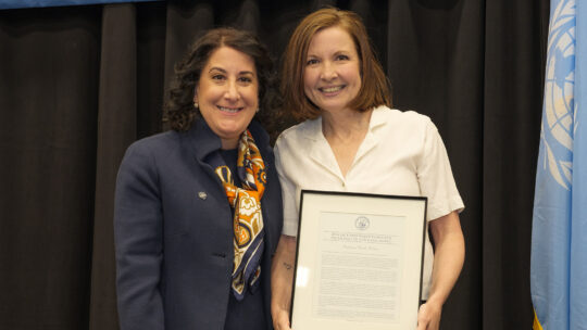 President Suzanne Rivera and Professor stands with Rossmann Award recipient Wendy Weber