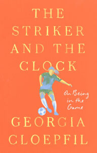 Orange book cover with THE STRIKER AND THE CLOCK in yellow text and artwork of a woman kicking a soccer ball