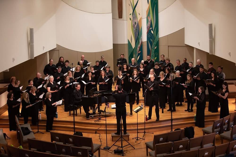 Macalester’s Mike McGaghie conducts the Isthmus Vocal Ensemble in concert.