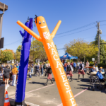 Macalester-branded inflatable air dancers wave at the M Club Cookout during Mac Fest 2025.