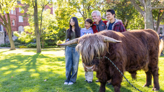Macalester family poses with Hartnett the cow