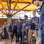 A student group performs on stage in the Campus Center during Mac Fest 2025