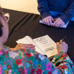 Kao Kalia Yang signs her book Where Rivers Part