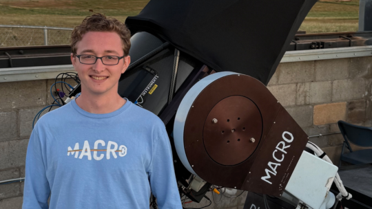 Jackson Codd ’23, co-author of the newly accepted MACRO Consortium paper, stands beside the Robert L. Mutel Telescope in southern Arizona during sunset.