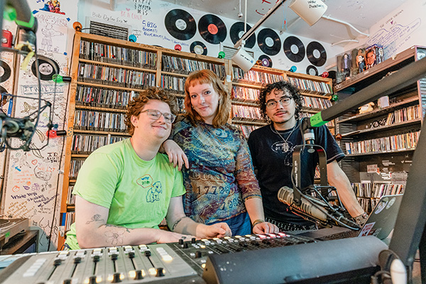 Three Macalester students pose for a photo at the WMCN studio