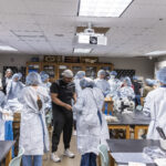 Dr. Malik Mays ’19 works with Macalester students in the lab.