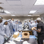 Dr. Malik Mays ’19 works with Macalester students in the lab.