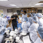 Dr. Malik Mays ’19 works with Macalester students in the lab.