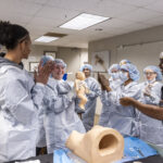 Dr. Malik Mays ’19 works with Macalester students in the lab.