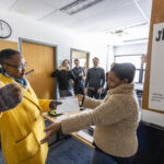 Executive Vice President and Provost Lisa Anderson-Levy and Professor Gardner reach for a hug.