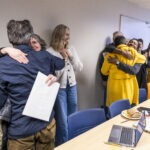 Executive Vice President and Provost Lisa Anderson-Levy celebrates with professors Maddux and James.