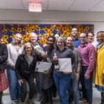 Executive Vice President and Provost Lisa Anderson-Levy stands with professors Maddux and James and a group of supporters.