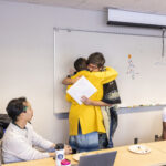 Executive Vice President and Provost Lisa Anderson-Levy hugs Professor Rivera.