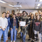 Executive Vice President and Provost Lisa Anderson-Levy stands with Professor Rivera and a group of supporters.