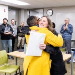 Executive Vice President and Provost Lisa Anderson-Levy hugs Professor Grinde.