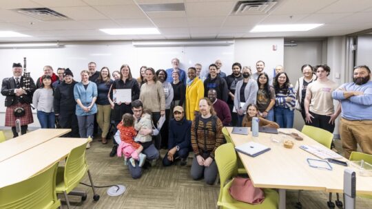 Executive Vice President and Provost Lisa Anderson-Levy stands with Professor Grinde and a group of supporters.