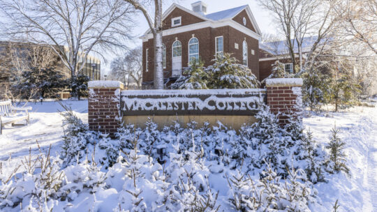 Macalester College welcome sign covered in snow