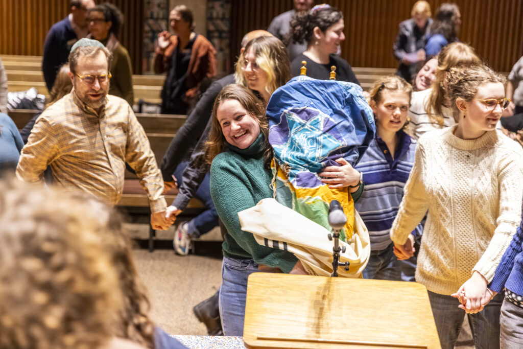 Gabi Isaac-Herzog '22 carrying the Torah during a moment of celebration at the scroll welcoming celebration.