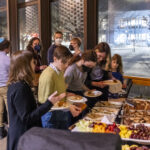 Community members enjoy nosh, a light meal, during the welcoming ceremony.