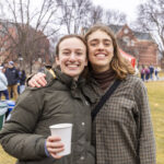 Two students smile for the camera
