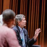 Panelist speaking from a stage