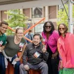 Group of six alumni posing for the camera