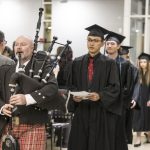 Director of Piping Mike Breidenbach leads graduates into Macalester's 2022 December graduation ceremony.