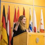 A student speaking at a microphone