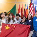 Six students hold the Chinese flag