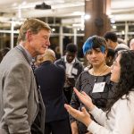 Phil Geier talks to two students