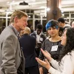 Phil Geier talks to two students