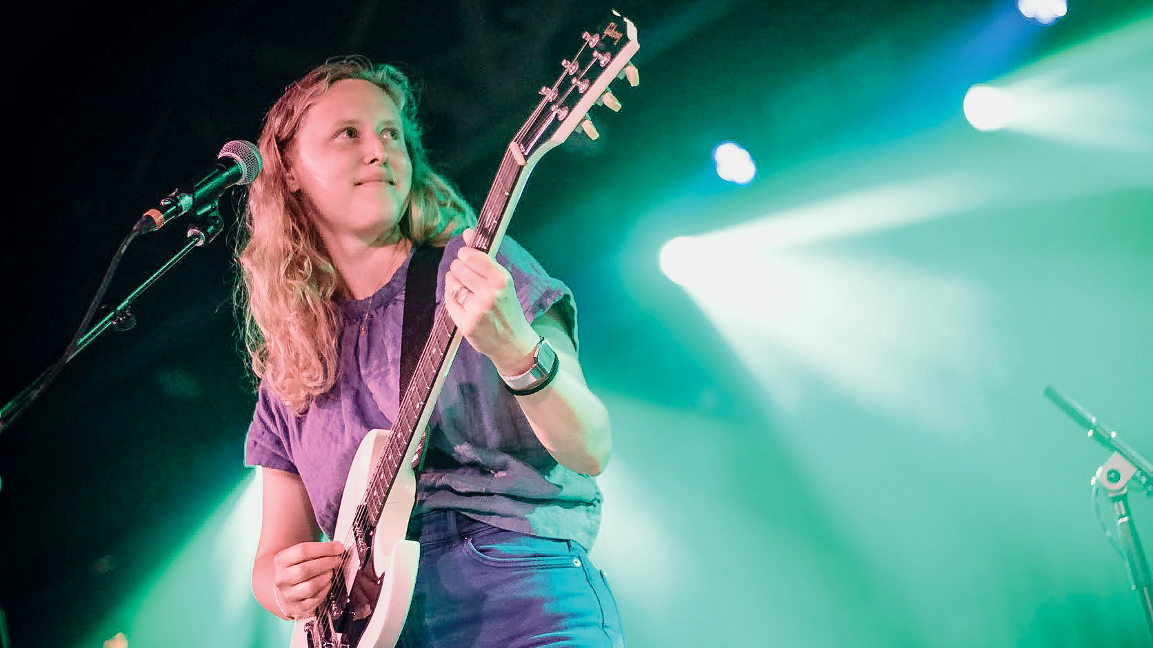 Kerry Alexander playing electric guitar on a stage