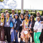 Thirteen Black alumni, some wearing Golden Scots medals, pose for a picture