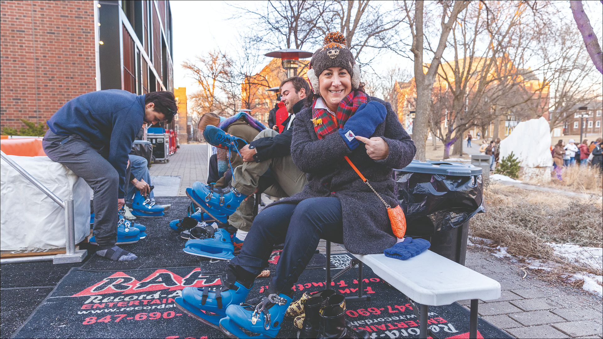 President Rivera smiles and points to her Mac mittens while putting on ice skates at the Brighter campaign launch
