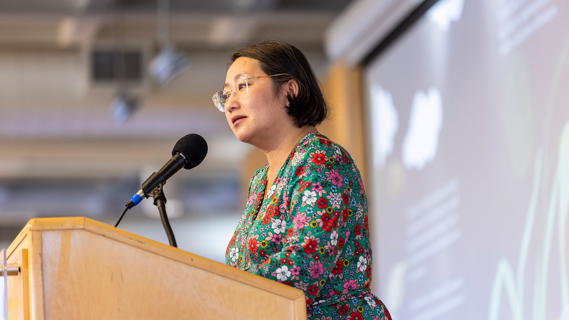 Kao Kalia Yang stands at a podium and speaks