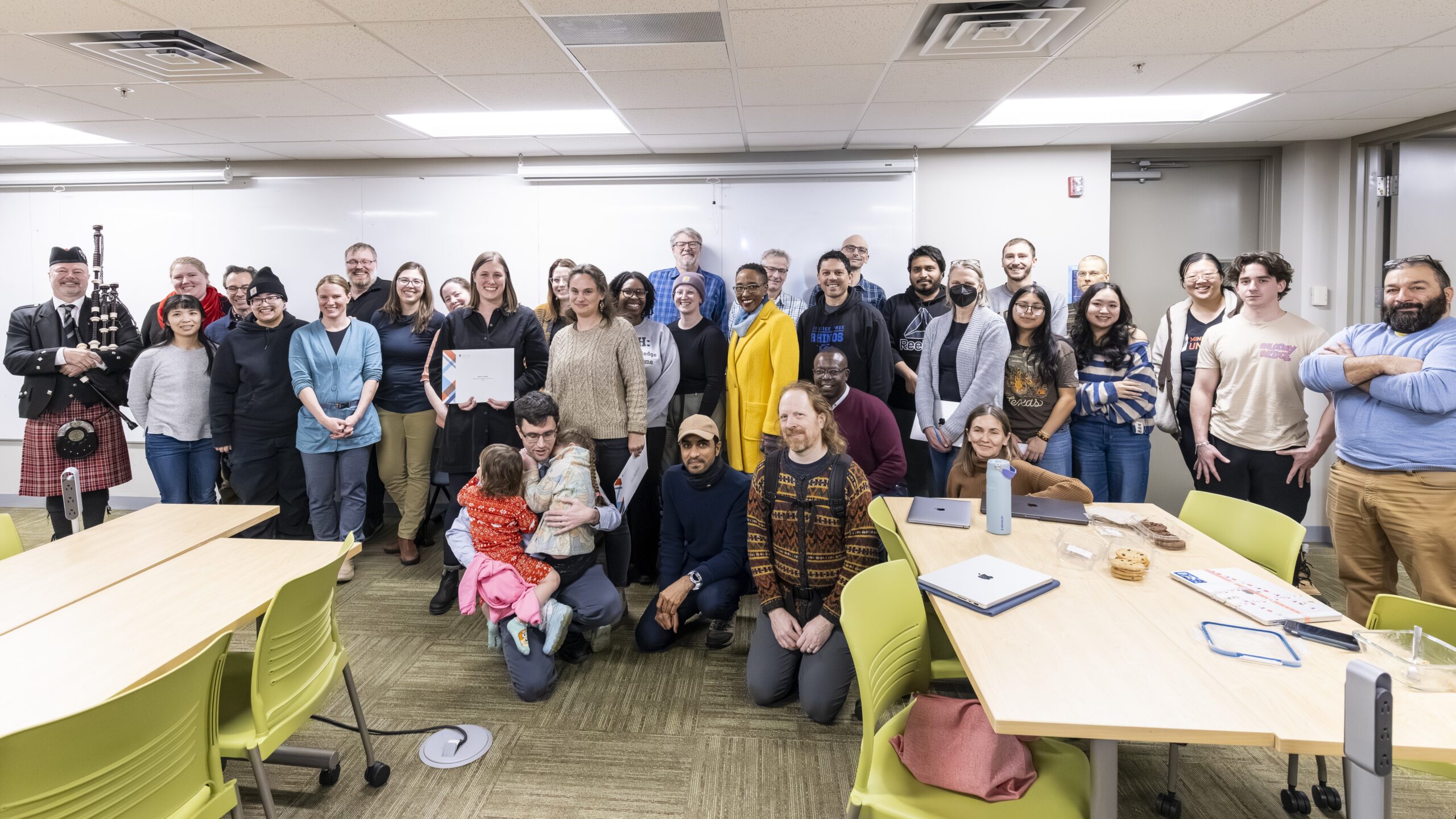 Executive Vice President and Provost Lisa Anderson-Levy stands with Professor Grinde and a group of supporters.