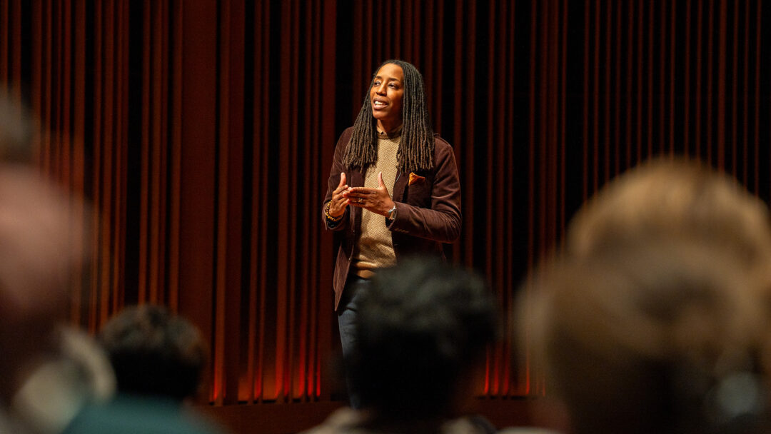 Dr. Bettina Love stands on a stage and speaks